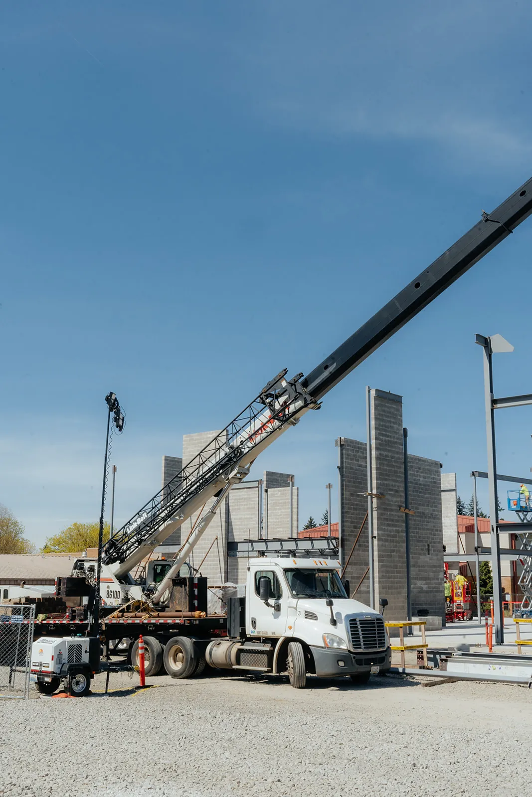 Westmore Link-Belt truck crane set up beside tilt-up concrete panels at a commercial jobsite