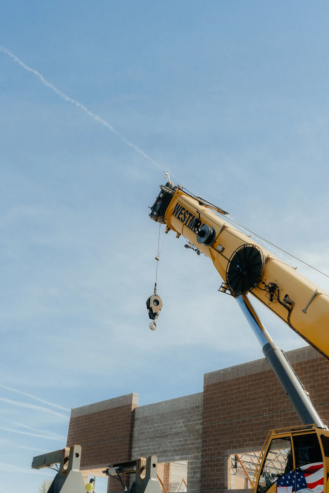 Westmore Grove crane hook block raised beside a brick building
