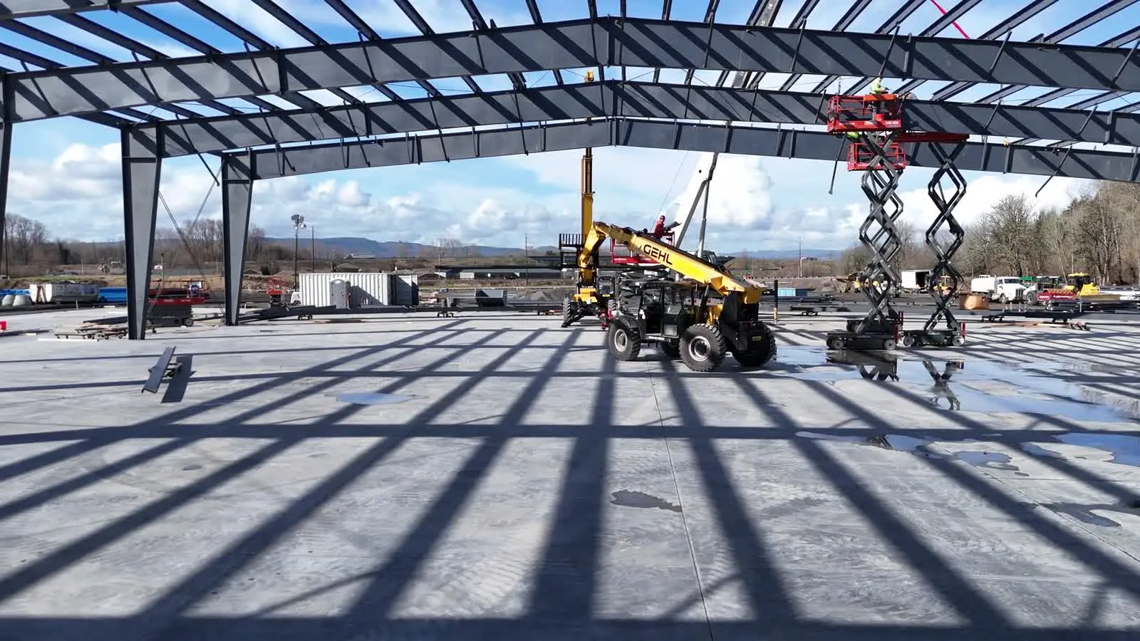 Aerial drone view of Westmore cranes erecting the Builders FirstSource steel frame